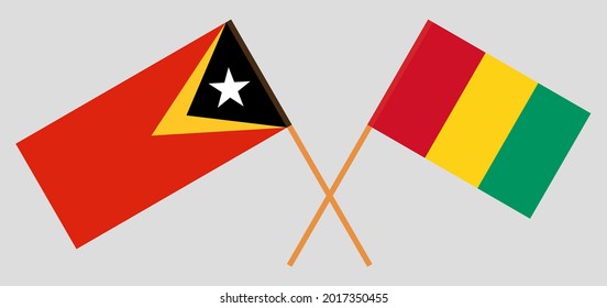 Banderas cruzadas de Timor Oriental y Guinea. Colores oficiales. Proporción correcta