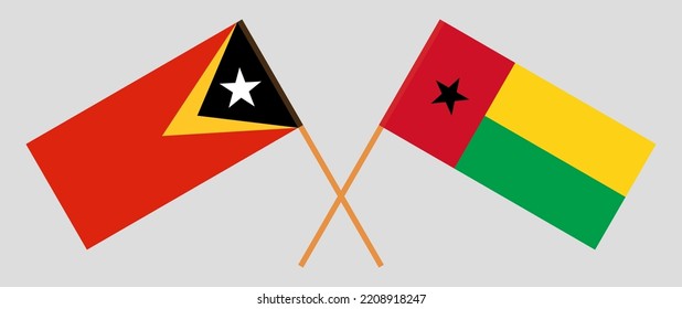 Crossed flags of East Timor and Guinea-Bissau. Official colors. Correct proportion. Vector illustration
