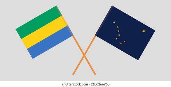 Crossed flags of Gabon and the State of Alaska. Official colors. Correct proportion. Vector illustration
