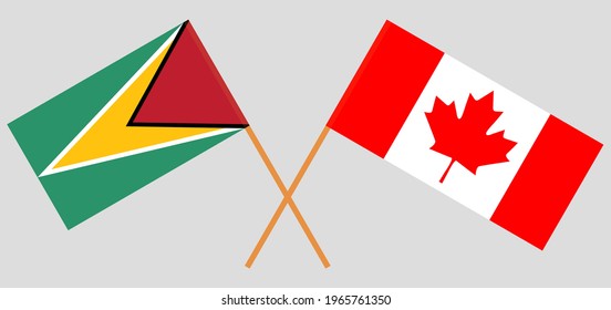 Crossed flags of Guyana and Canada. Official colors. Correct proportion