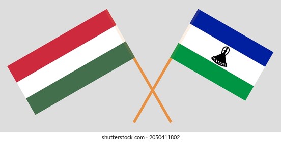 Überquerte Flaggen Ungarns und des Königreichs Lesotho. Offizielle Farben. Richtiger Anteil