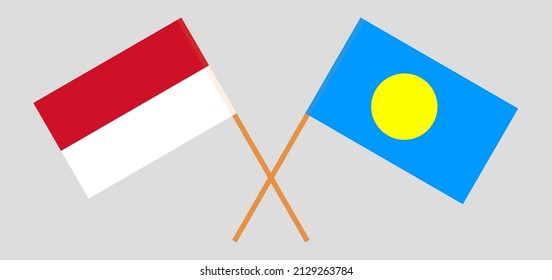Crossed flags of Indonesia and Palau. Official colors. Correct proportion. Vector illustration

