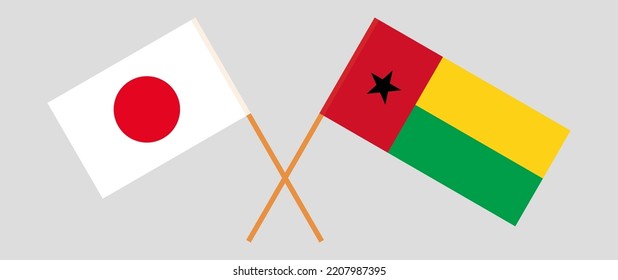 Crossed flags of Japan and Guinea-Bissau. Official colors. Correct proportion. Vector illustration
