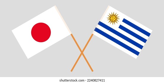 Crossed flags of Japan and Uruguay. Official colors. Correct proportion. Vector illustration
