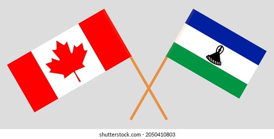 Crossed flags of the Kingdom of Lesotho and Canada. Official colors. Correct proportion