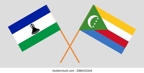 Crossed flags of the Kingdom of Lesotho and the Comoros. Official colors. Correct proportion. Vector illustration
