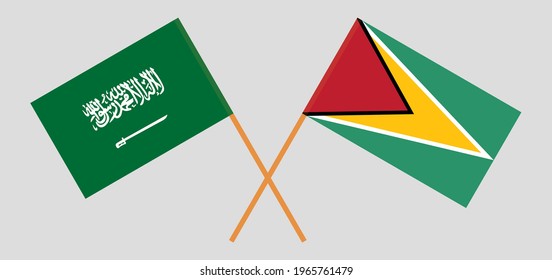 Crossed flags of the Kingdom of Saudi Arabia and Guyana. Official colors. Correct proportion