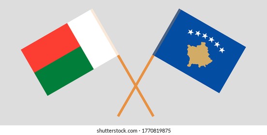 Crossed flags of Kosovo and Madagascar. Official colors. Correct proportion. Vector illustration
