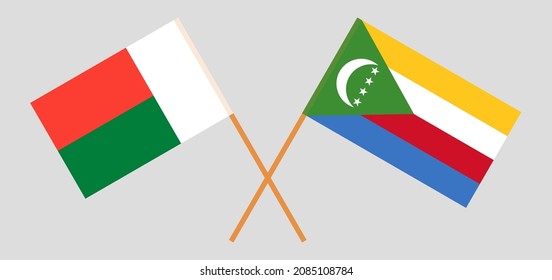 Crossed flags of Madagascar and the Comoros. Official colors. Correct proportion. Vector illustration
