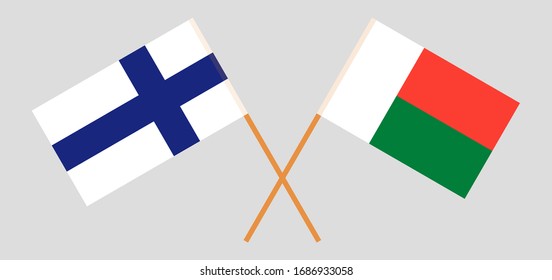 Crossed flags of Madagascar and Finland. Official colors. Correct proportion. Vector illustration
