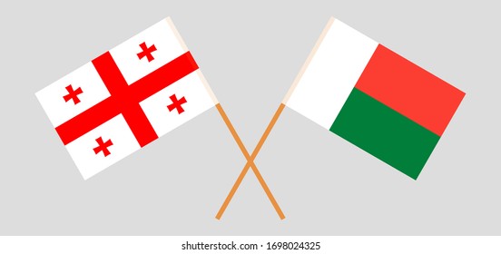 Crossed flags of Madagascar and Georgia. Official colors. Correct proportion. Vector illustration
