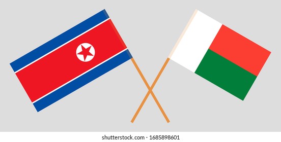 Crossed flags of Madagascar and North Korea. Official colors. Correct proportion. Vector illustration
