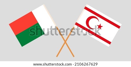 Crossed flags of Madagascar and Northern Cyprus. Official colors. Correct proportion. Vector illustration
