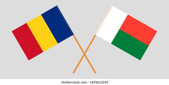 Crossed flags of Madagascar and Romania. Official colors. Correct proportion. Vector illustration
