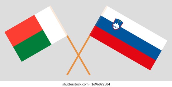 Crossed flags of Madagascar and Slovenia. Official colors. Correct proportion. Vector illustration
