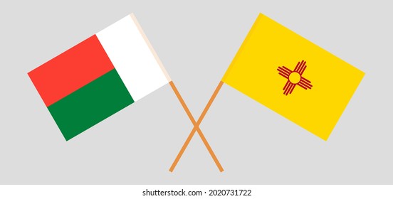 Crossed flags of Madagascar and the State of New Mexico. Official colors. Correct proportion