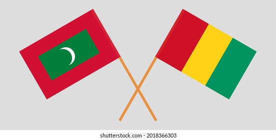 Crossed flags of Maldives and Guinea. Official colors. Correct proportion