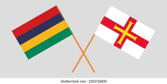 Crossed flags of Mauritius and Bailiwick of Guernsey. Official colors. Correct proportion. Vector illustration
