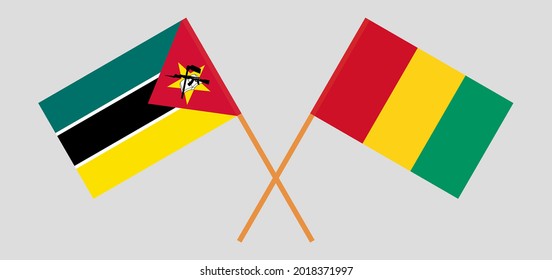 Crossed flags of Mozambique and Guinea. Official colors. Correct proportion.