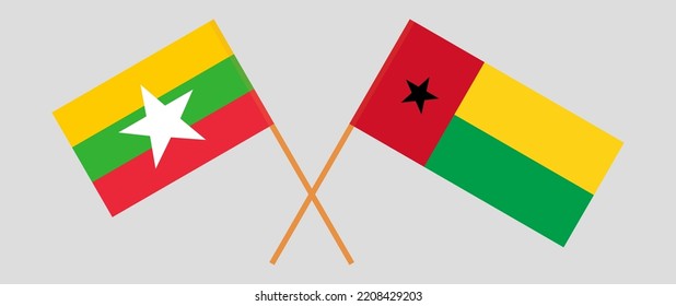 Crossed flags of Myanmar and Guinea-Bissau. Official colors. Correct proportion. Vector illustration
