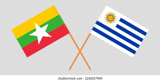 Crossed flags of Myanmar and Uruguay. Official colors. Correct proportion. Vector illustration

