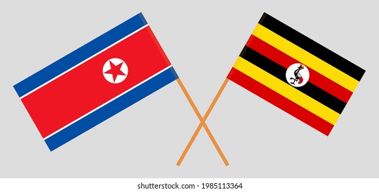 Crossed flags of North Korea and Uganda. Official colors. Correct proportion