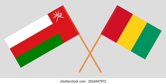 Banderas cruzadas de Omán y Guinea. Colores oficiales. Proporción correcta