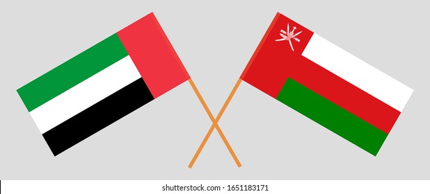 Crossed flags of Oman and the United Arab Emirates. Official colors. Correct proportion. Vector illustration
