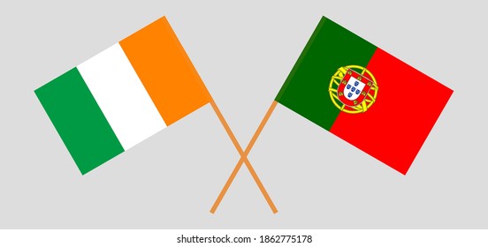 Crossed flags of Portugal and Republic of Ivory Coast