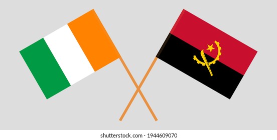 Gekreuzte Flaggen der Republik Côte d'Ivoire und Angolas. Offizielle Farben. Richtiger Anteil