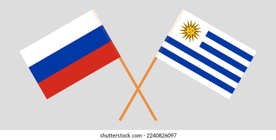 Crossed flags of Russia and Uruguay. Official colors. Correct proportion. Vector illustration
