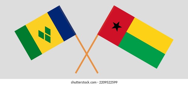 Crossed flags of Saint Vincent and the Grenadines and Guinea-Bissau. Official colors. Correct proportion. Vector illustration
