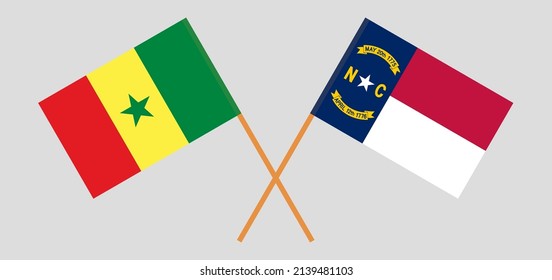 Crossed flags of Senegal and The State of North Carolina. Official colors. Correct proportion. Vector illustration
