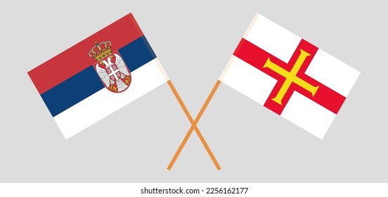 Crossed flags of Serbia and Bailiwick of Guernsey. Official colors. Correct proportion. Vector illustration
