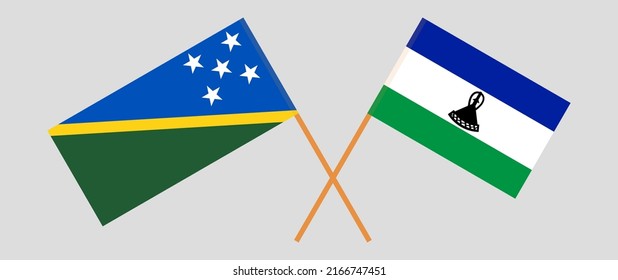 Crossed flags of Solomon Islands and Lesotho. Official colors. Correct proportion. Vector illustration
