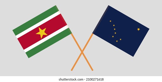 Crossed flags of Suriname and the State of Alaska. Official colors. Correct proportion. Vector illustration
