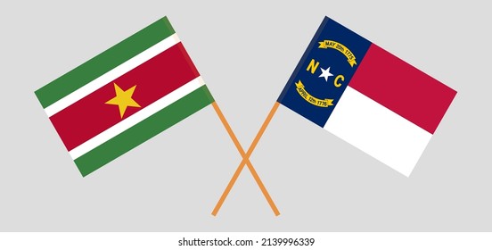 Crossed flags of Suriname and The State of North Carolina. Official colors. Correct proportion. Vector illustration
