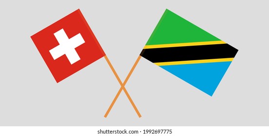 Crossed flags of Switzerland and Tanzania. Official colors. Correct proportion