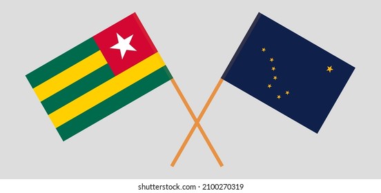 Crossed flags of Togo and the State of Alaska. Official colors. Correct proportion. Vector illustration
