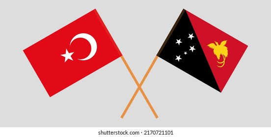 Crossed flags of Turkiye and Papua New Guinea. Official colors. Correct proportion. Vector illustration
