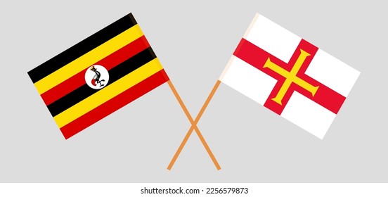 Crossed flags of Uganda and Bailiwick of Guernsey. Official colors. Correct proportion. Vector illustration
