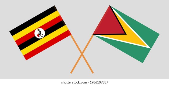 Crossed flags of Uganda and Guyana. Official colors. Correct proportion