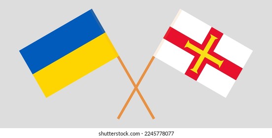 Crossed flags of Ukraine and Bailiwick of Guernsey. Official colors. Correct proportion. Vector illustration
