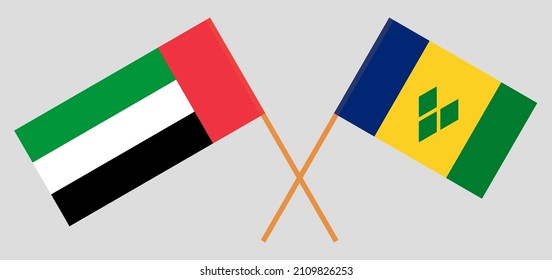 Crossed flags of the United Arab Emirates and Saint Vincent and the Grenadines. Official colors. Correct proportion. Vector illustration
