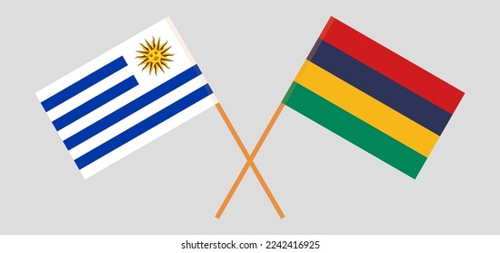 Crossed flags of Uruguay and Mauritius. Official colors. Correct proportion. Vector illustration
