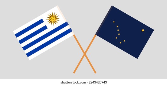 Crossed flags of Uruguay and the State of Alaska. Official colors. Correct proportion. Vector illustration
