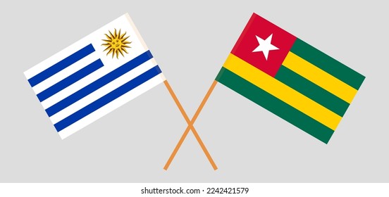 Crossed flags of Uruguay and Togo. Official colors. Correct proportion. Vector illustration
