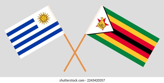 Crossed flags of Uruguay and Zimbabwe. Official colors. Correct proportion. Vector illustration
