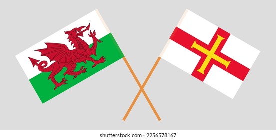 Crossed flags of Wales and Bailiwick of Guernsey. Official colors. Correct proportion. Vector illustration
