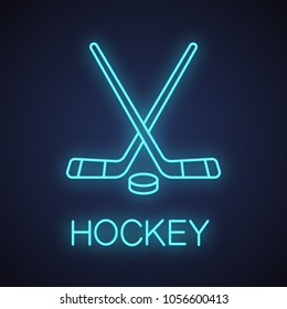 Crossed Hockey Sticks With Puck Neon Light Icon. Ice Hockey Equipment. Glowing Sign. Vector Isolated Illustration